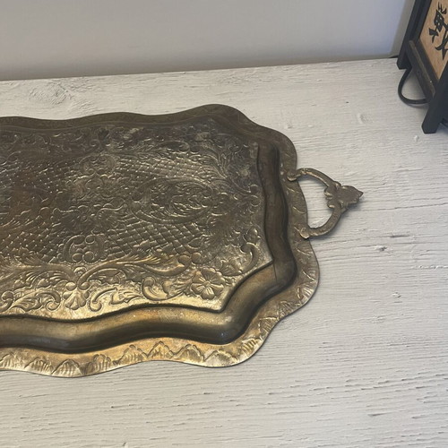 Vintage metal serving tray used with embossed floral and geometric carvings