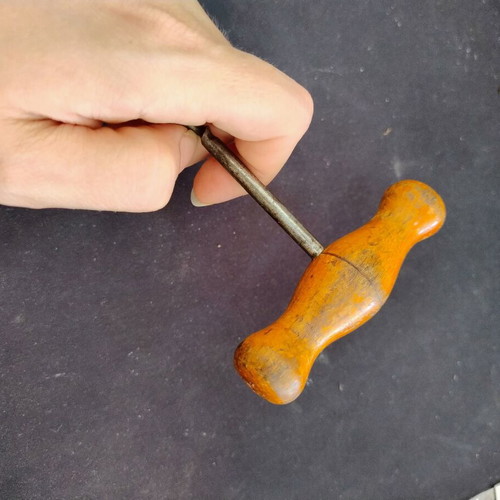 Vintage bottle opener with wooden handle used