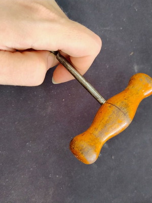 Vintage bottle opener with wooden handle used