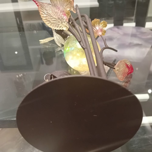 Decorative candle holder with metal tree base, used