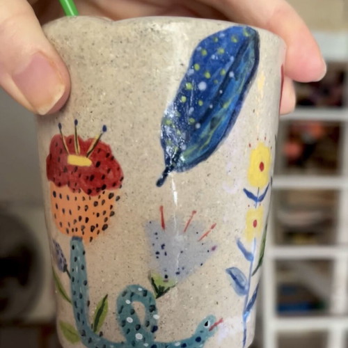 Illustrative ceramic mug handmade with floral design