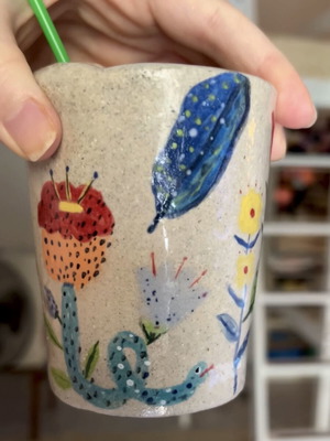 Illustrative ceramic mug handmade with floral design