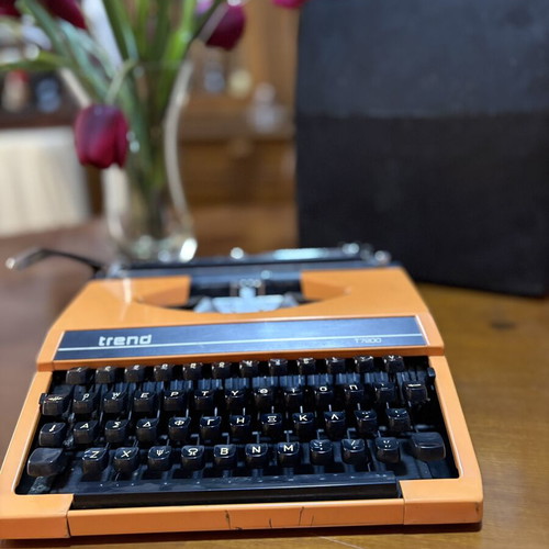 Vintage Trend Typewriter used with ribbon and case, orange color