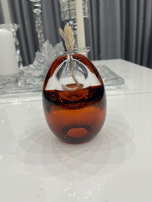 Modern oval glass candle holder used with wick