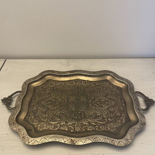 Vintage metal serving tray used with embossed floral and geometric carvings