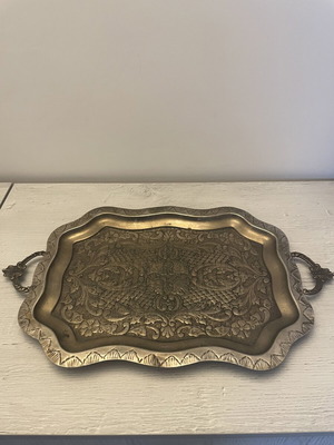 Vintage metal serving tray used with embossed floral and geometric carvings