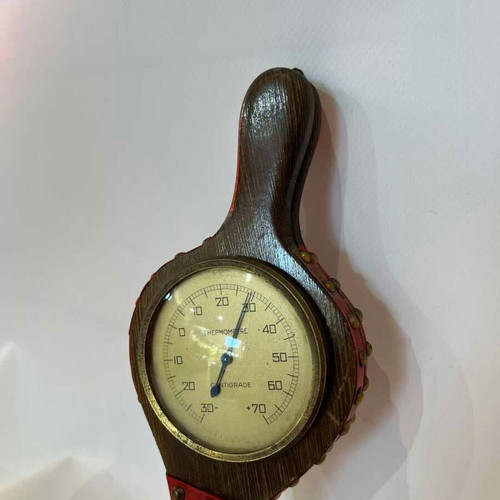 Vintage wall thermometer shaped like a fireplace bellows used