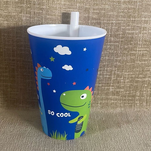 Plastic cup with dinosaur design and straw used
