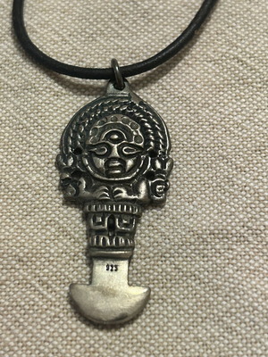 Silver pendant with Mama Quilla relief, like new, leather cord