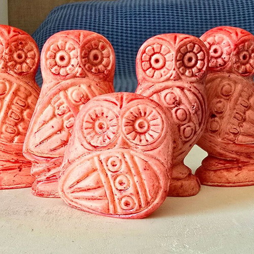 Set of five salmon pink owl figurines