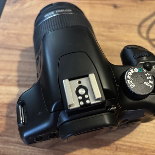 Canon EOS 450D camera used with charger and straps