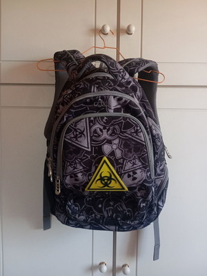 Polo character school backpack with multiple compartments