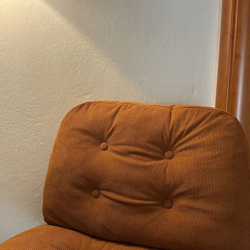 Modern swivel armchair, terracotta fabric and metal