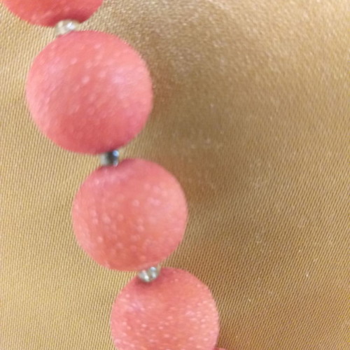 Orange-red necklace with textured stones used