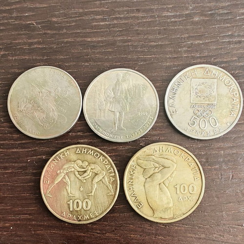 Sports-themed coins used, two 100 and three 500 drachmas