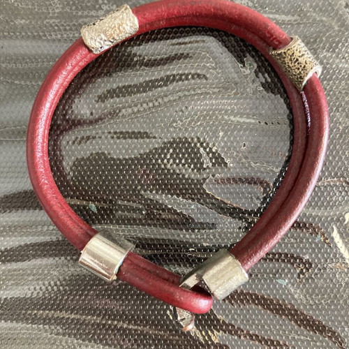 Leather cord bracelet with silver-tone metal accents