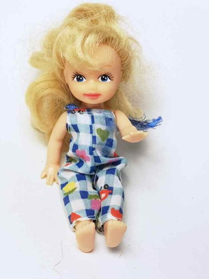Plastic doll used with torn clothes