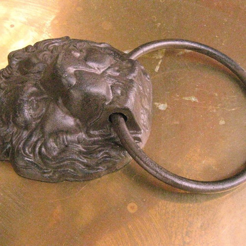Cast iron door knocker used with lion head