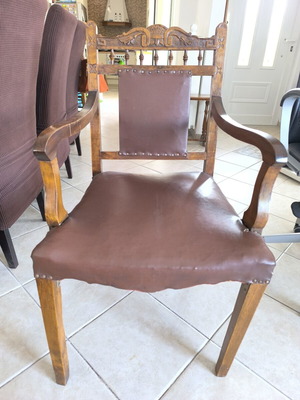 Vintage armchair refurbished with carved wood and leather backrest