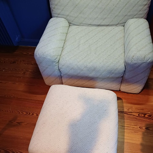 Armchair with fabric upholstery and footstool used, wooden legs