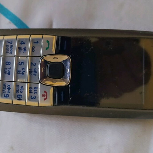 Old mobile phone used, functional, almost unused, gray with game