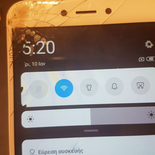Xiaomi Redmi 4X smartphone with cracked screen, gold