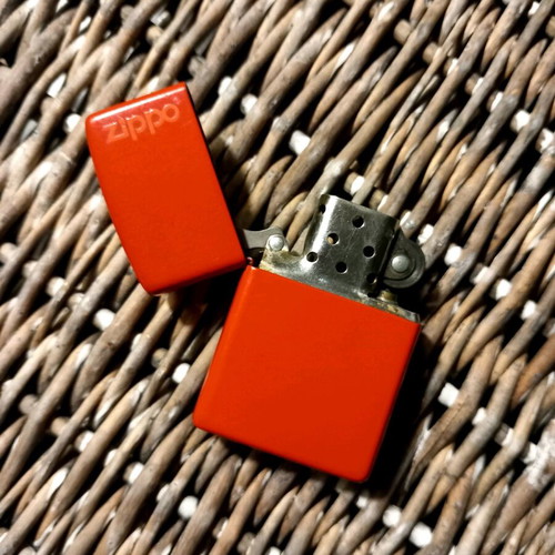 Zippo lighter used, large bright red