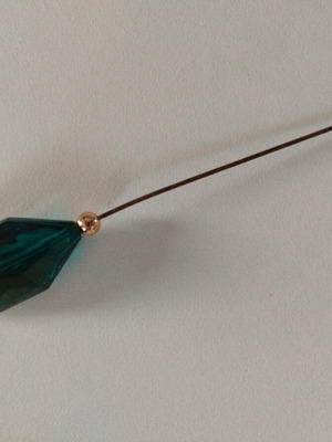 Pin with large green crystal