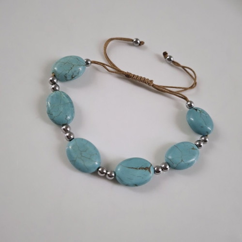 Handmade turquoise bracelet with silver details, adjustable cord