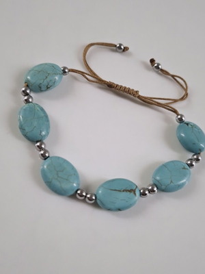 Handmade turquoise bracelet with silver details, adjustable cord