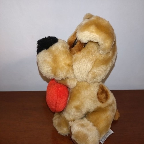 Plush dog used with red heart