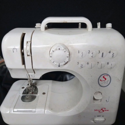 Mini sewing machine used for parts or decor, battery operated