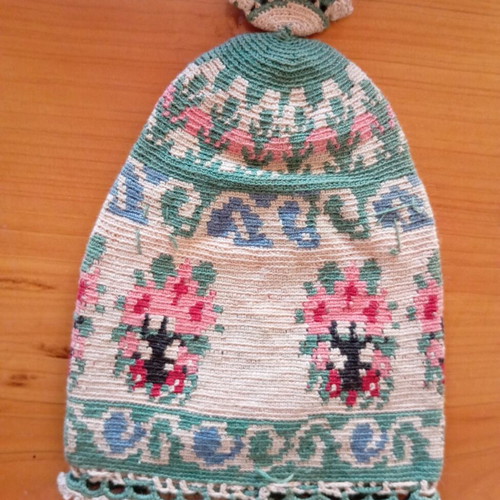 Handmade traditional embroidered or knitted pouch hat with folk motifs