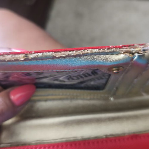 Juicy Couture red wallet used with side wear on gold details