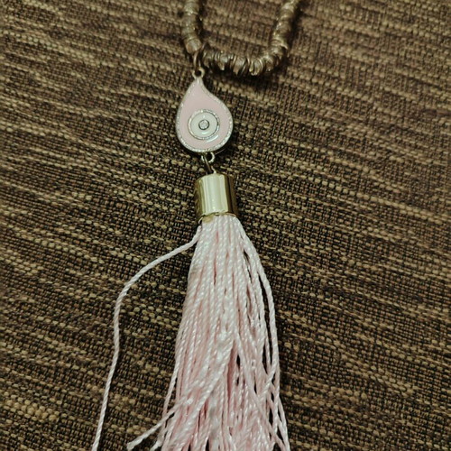 Long necklace used with pink evil eye and tassel