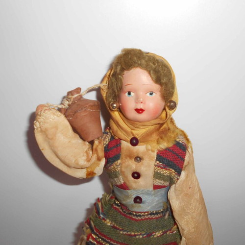Folk handmade doll used with traditional costume and water jug