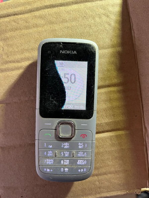 Nokia C1 phone used with broken screen without battery