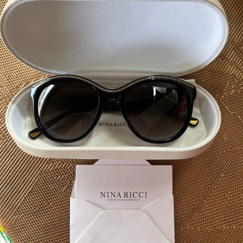 Nina Ricci SNR097 sunglasses like new, black oval acetate frame with chain design