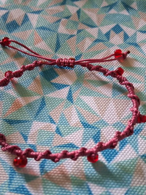 Macrame bracelet with decorative red beads, like new