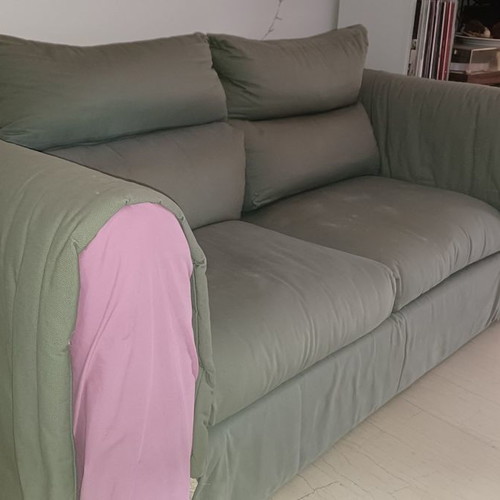 Two-seater sofa used, gray with purple-pink fabric on arms