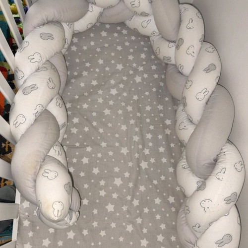 Baby braided crib bumper used in gray and white