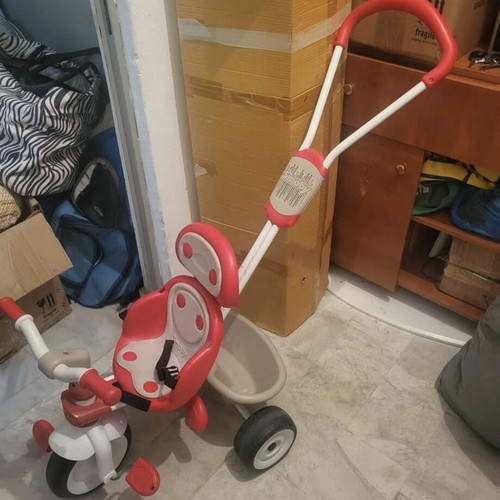 Children's tricycle used with sun canopy and safety handle