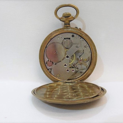 Old brass pocket watch with embossed design