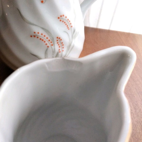 Porcelain teapot and creamer set like new with embossed designs