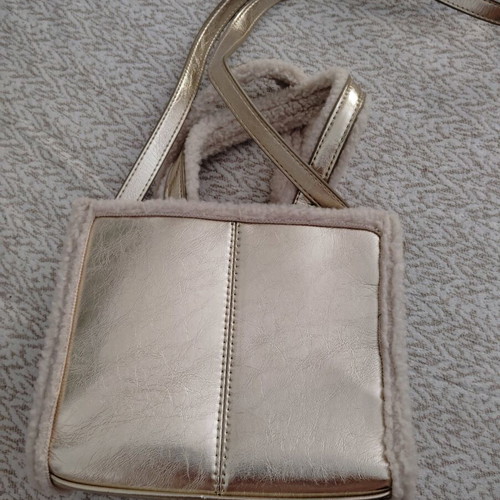 Handbag gold like new with fur details and long strap