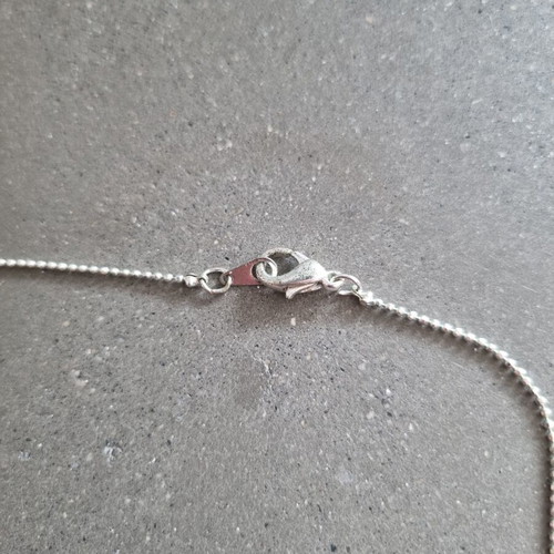 Necklace with hanging chain and stones