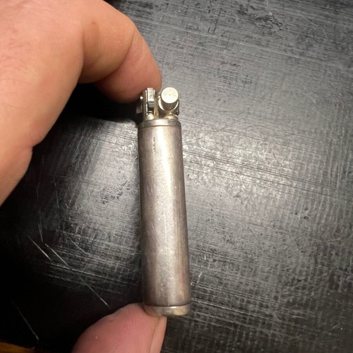 Silver lighter used, unknown if working