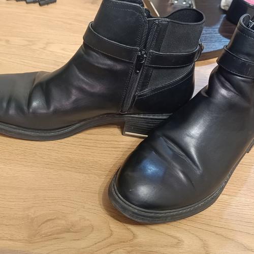 Black ankle Chelsea boots with buckle and gold details
