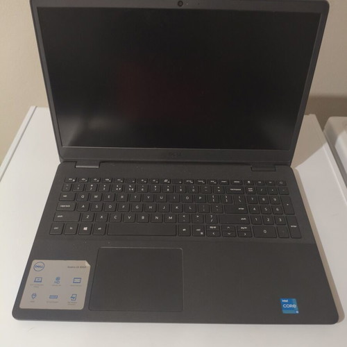 Dell Vostro 15 3000 laptop with 8GB RAM, charger, mouse, and case