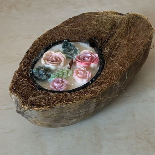 Handmade candle in natural coconut shell